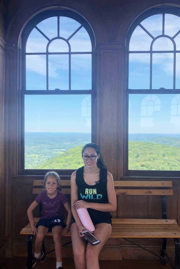 sitting in front of the windows at the top of heublein tower.