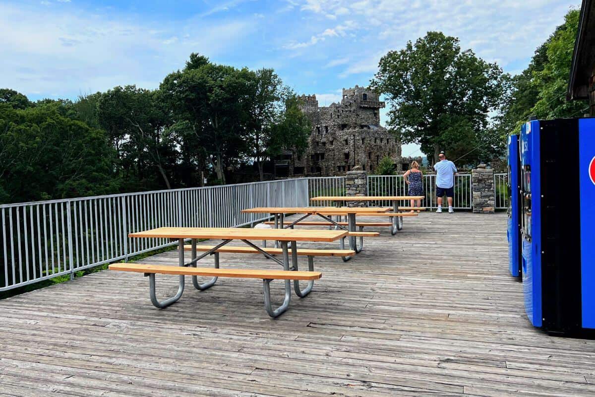 deck with picnic tables and castle in background.