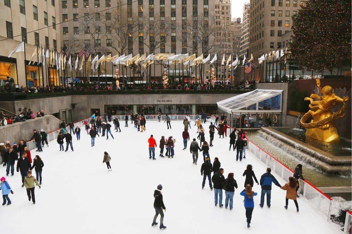 Ice skaters on rink at Rockefeller Center.