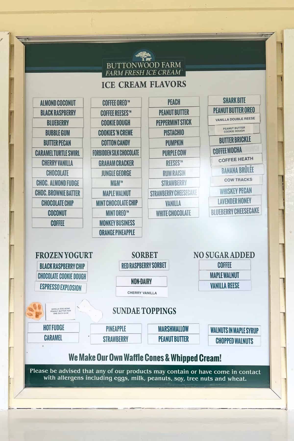 Buttonwood Farm ice cream menu board listing various ice cream, frozen yogurt, sorbet, and no sugar added flavors, plus sundae toppings and allergy information.