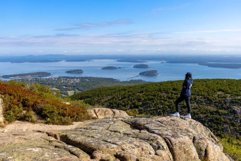 Breathtaking view from a mountain overlooking islands and lake in travel adventure scene.