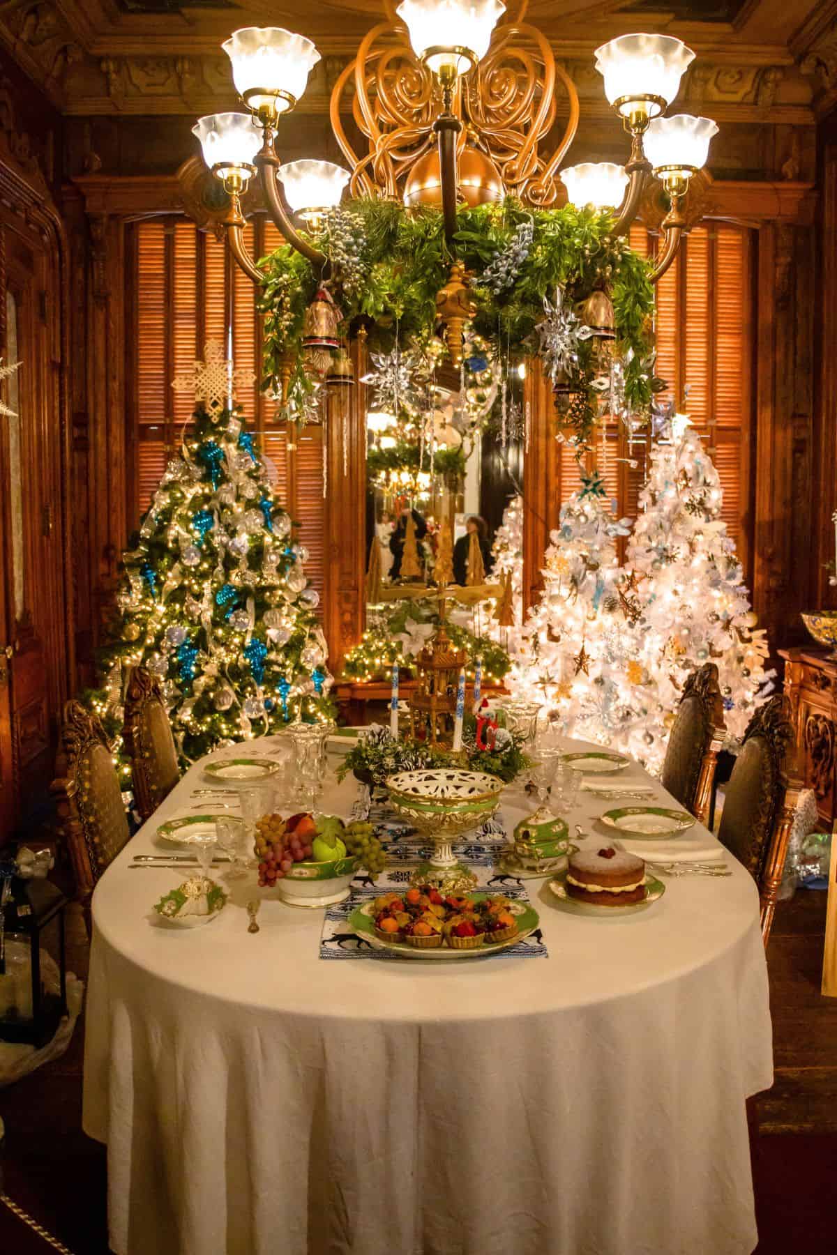 A table with food on it and decorated trees.