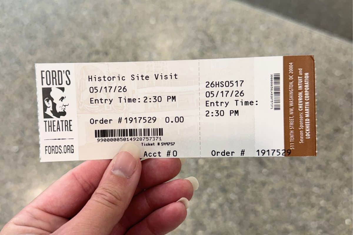 A hand holds a Ford's Theatre ticket for a historic site visit on May 17, 2026, with entry time at 2:30 PM.