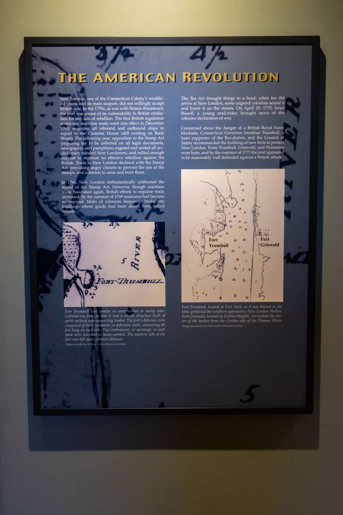 A museum display panel titled "The American Revolution" features explanatory text and two historical map excerpts related to river forts and British movements.