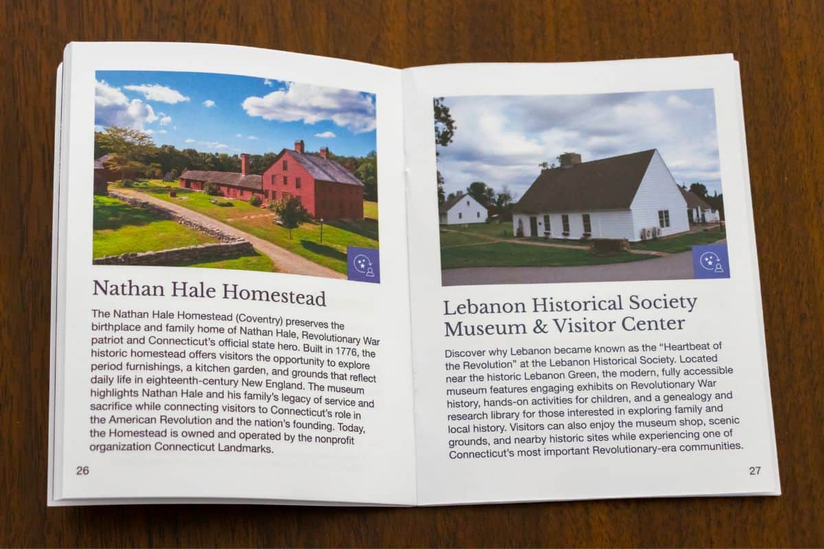 An open booklet on a wooden surface displays information and photos of Nathan Hale Homestead and Lebanon Historical Society Museum & Visitor Center, key sites along the Connecticut Revolutionary War Trail.