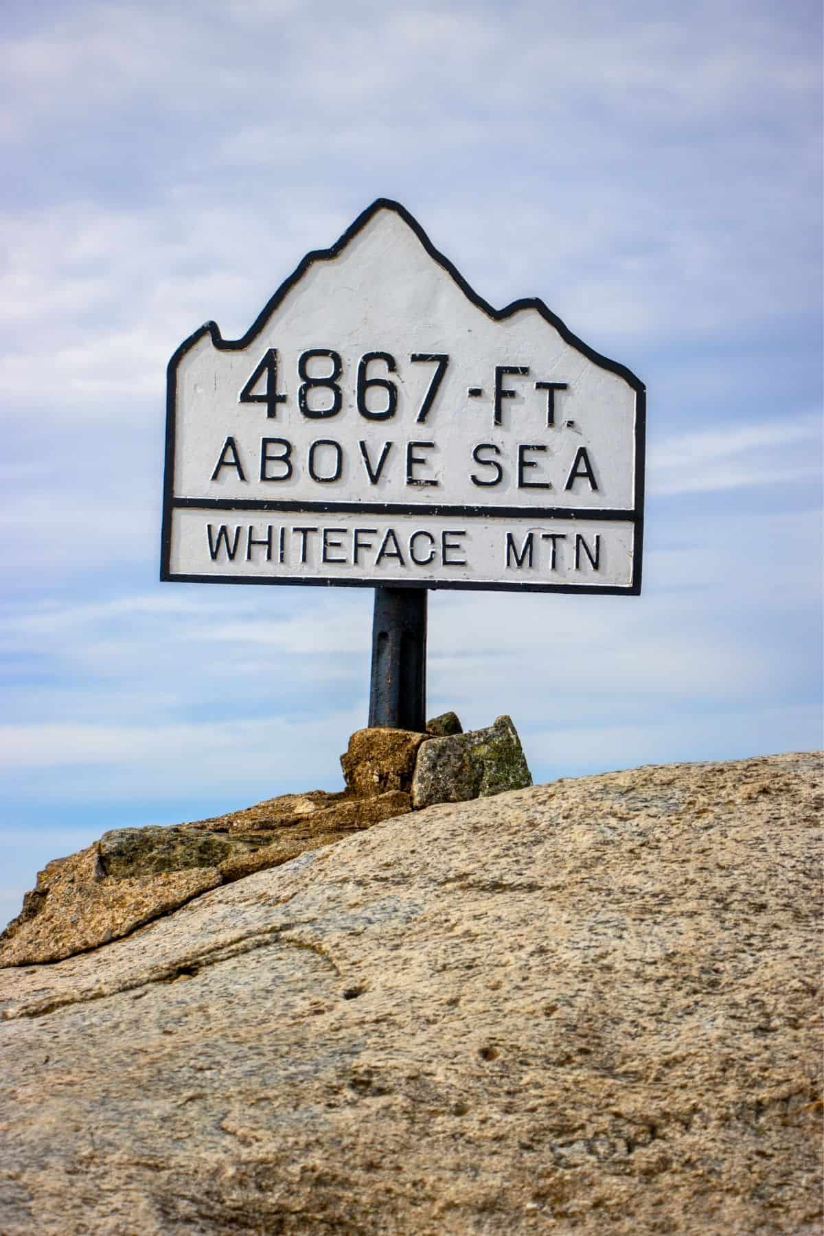 Sign on a rock summit reading, “4867 FT. ABOVE SEA LEVEL, WHITEFACE MTN.”